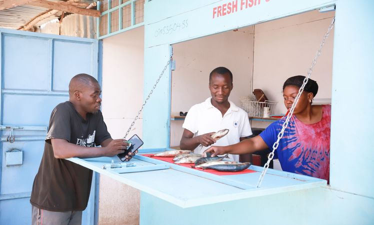 Man buying fish from a fish stall in Kakuma