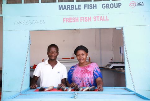 Two young people in their fish stall in Kakuma.